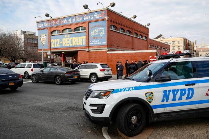New York City police officers work the scene of a police involved shooting outside the 41st pre ...
