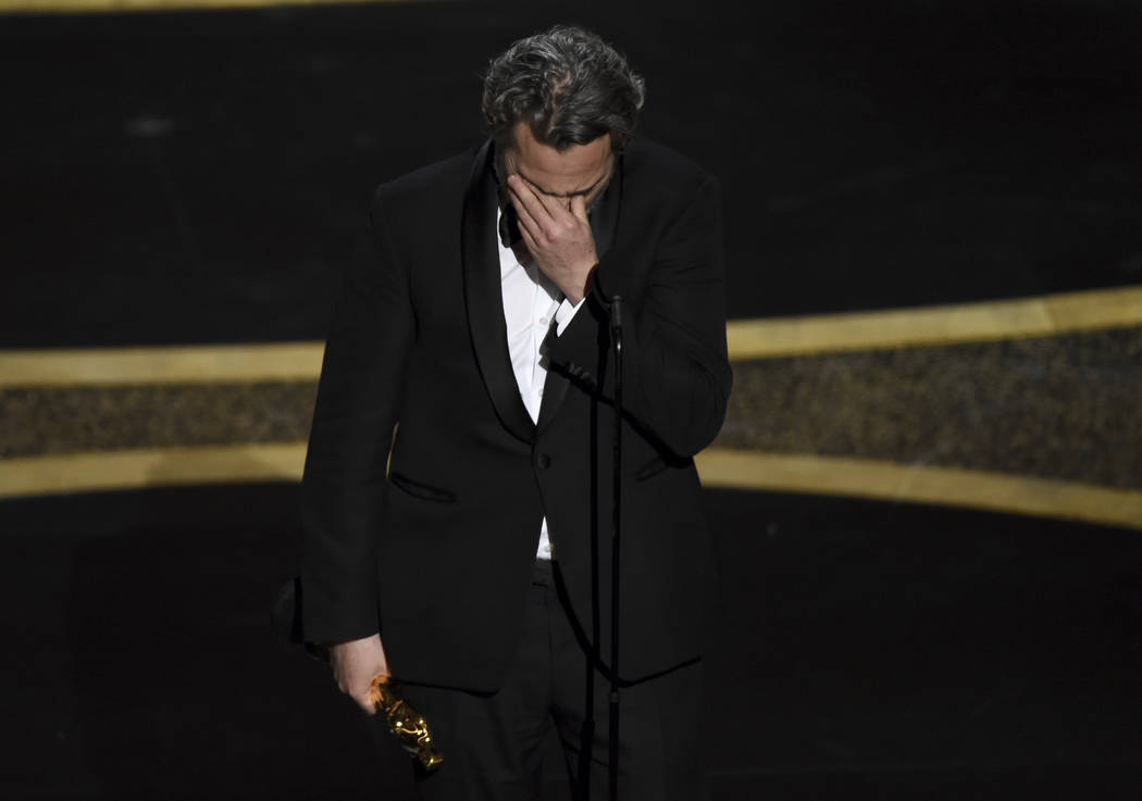 Joaquin Phoenix reacts as he accepts the award for best performance by an actor in a leading ro ...