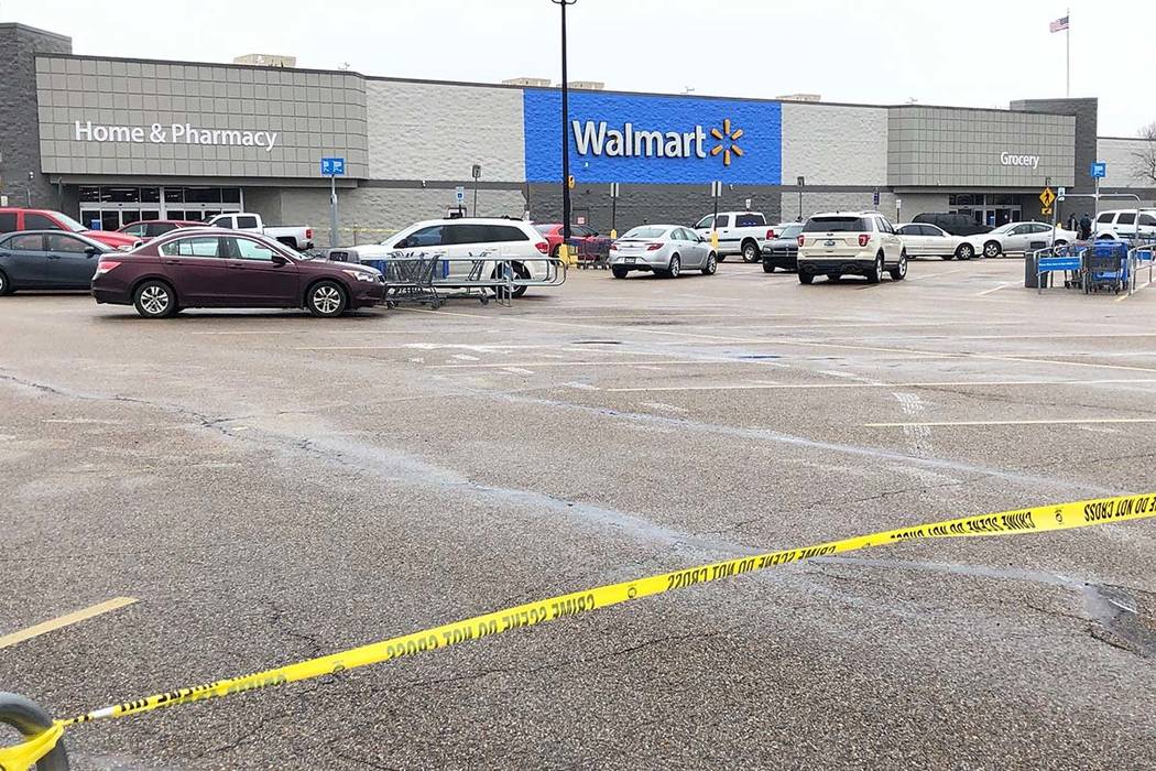 Police tape blocks off a Walmart store parking lot in Forrest City, Ark., on Monday, Feb. 10, 2 ...