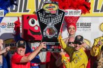 Joey Logano, right, and Carlos Maurer, president of Shell Lubricants Americas, hold the first p ...