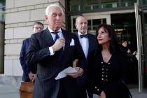 Roger Stone, left, with his wife Nydia Stone, leaves federal court in Washington, Friday, Nov. ...