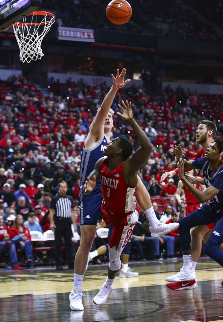 UNLV's Amauri Hardy (3) shoots to score over UNR's Zane Meeks (15) during the first half of a b ...