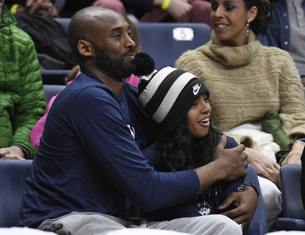 FILE - In this March 2, 2019, file photo Kobe Bryant and his daughter Gianna watch the first ha ...