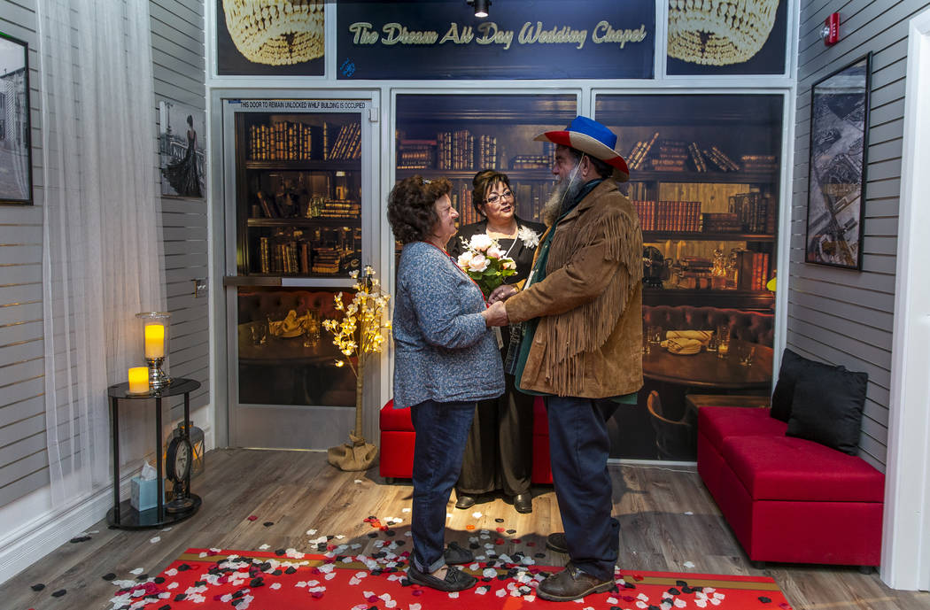 The Rev. Diana Moran, center, conducts a wedding renewal ceremony for Rose Mallory, left, and h ...