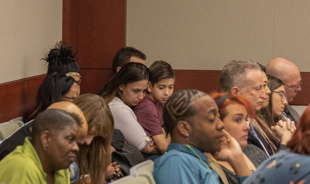 Displaced Alpine Motel Apartments tenants listen as the civil attorney for Las Vegas Dragon Hot ...