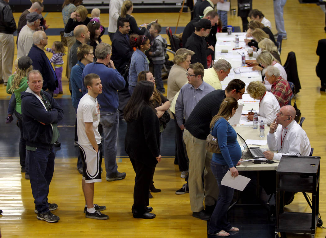 Voters wait to be check in at the voter verification station during the Republican caucus at Ce ...