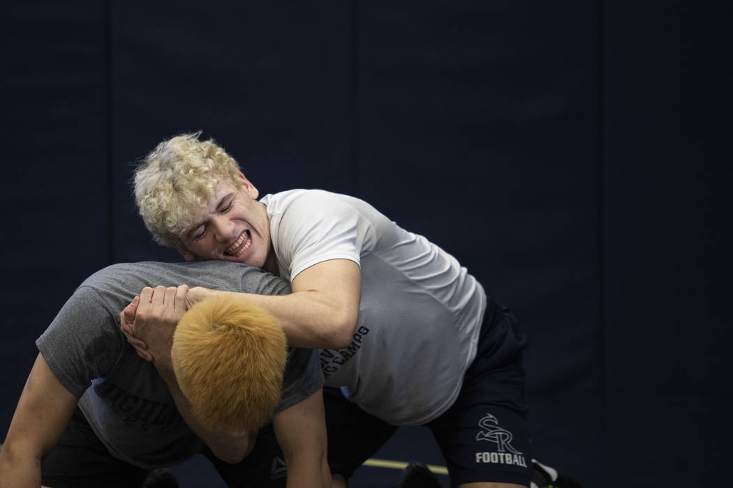 Senior Noah Gallardo, right, wrestles against senior Joel Hemintakoon, left, during wrestling p ...