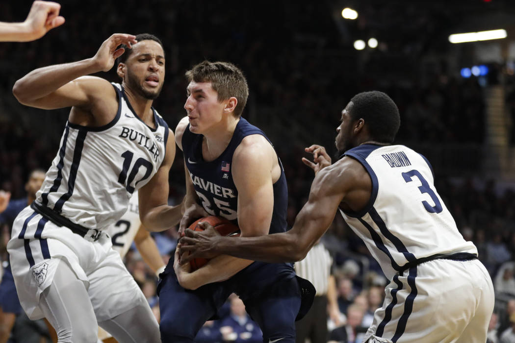 Xavier forward Jason Carter (25) tries to cut through Butler forward Bryce Nze (10) and guard K ...