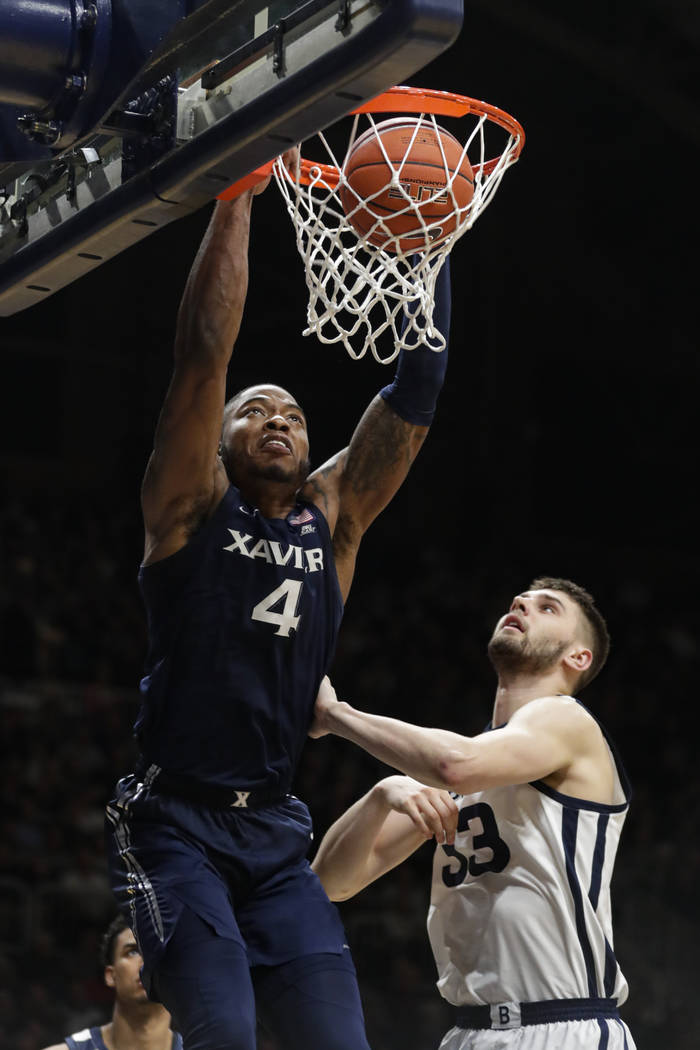 Xavier forward Tyrique Jones (4) gets a dunk over Butler forward Bryce Golden (33) in the secon ...