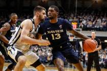 Xavier forward Naji Marshall (13) drives on Butler forward Bryce Golden (33) in the second half ...