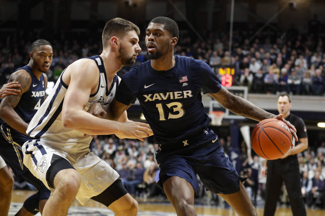 Xavier forward Naji Marshall (13) drives on Butler forward Bryce Golden (33) in the second half ...