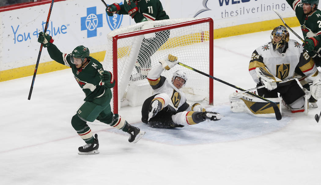 Minnesota Wild's Jared Spurgeon, left, celebrates his power play goal off Vegas Golden Knights' ...