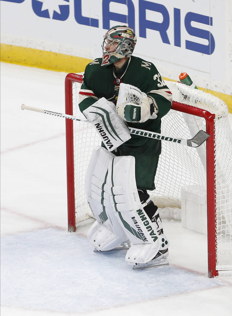 Minnesota Wild's Alex Stalock hits his hockey stick against the post as he celebrates his 4-0 s ...