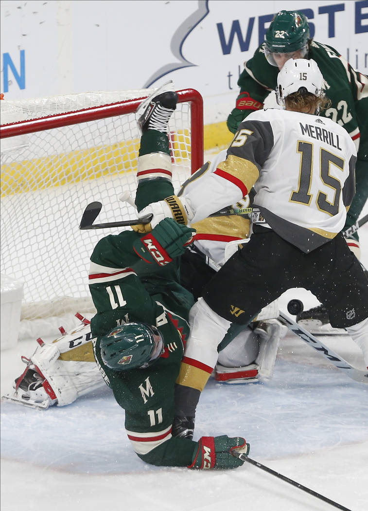 Minnesota Wild's Zach Parise, left, gets upended at the net by Vegas Golden Knights' Jon Merril ...