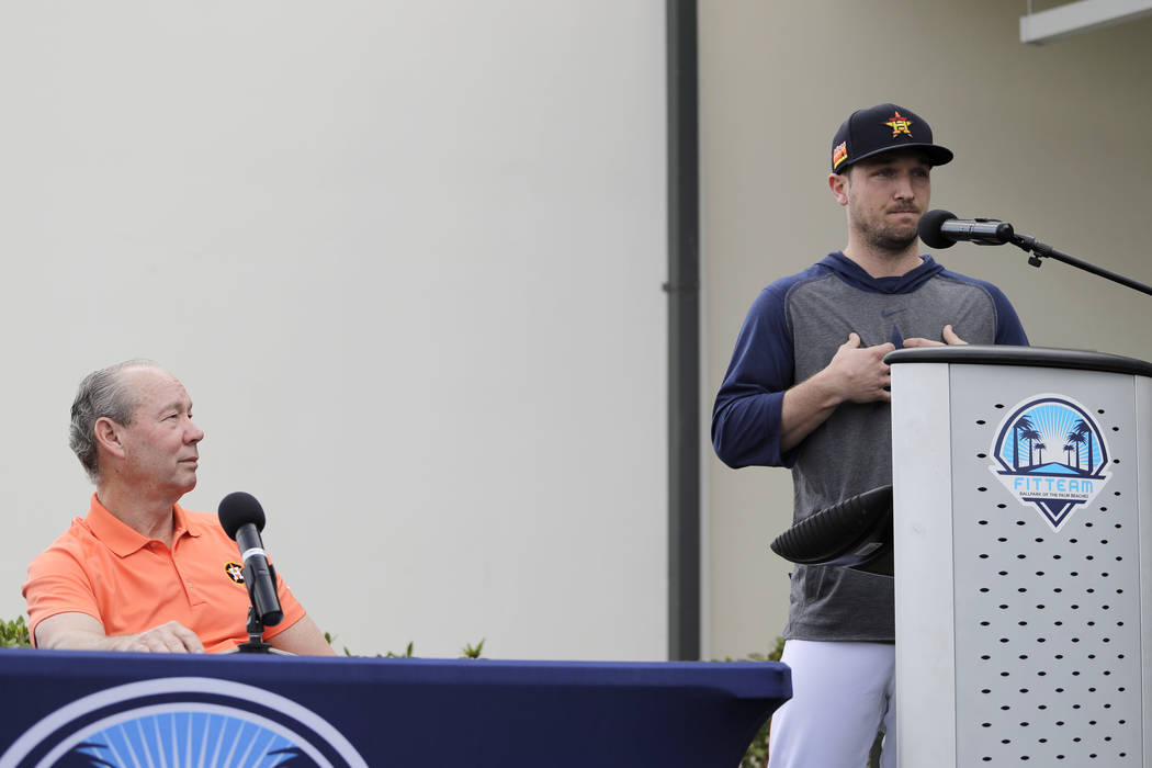Houston Astros' Alex Bregman, right, delivers a statement as Astros owner Jim Crane listens dur ...
