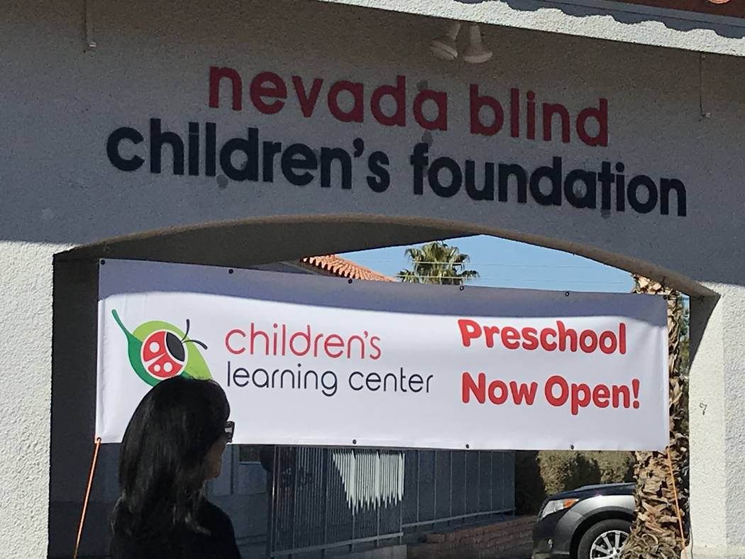 A ribbon cutting ceremony attendee walks Feb. 12 in front of the Nevada Blind Children’s Foun ...
