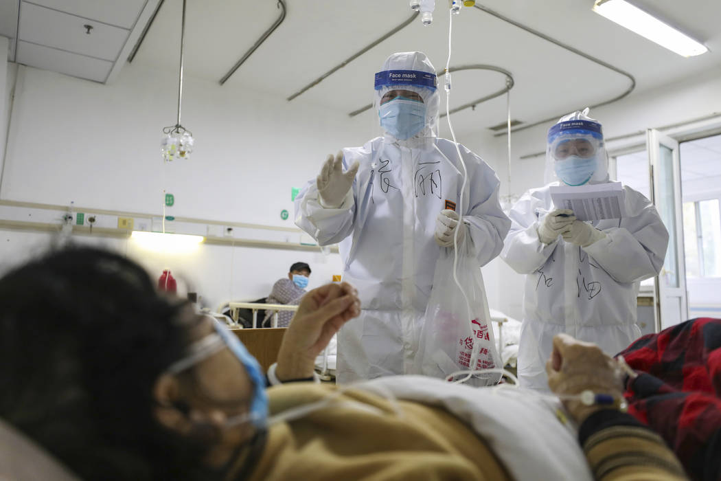 Medical workers check on the conditions of patients in Jinyintan Hospital, designated for criti ...