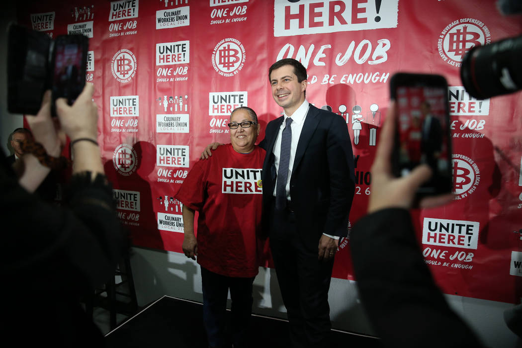 Democratic presidential candidate Pete Buttigieg, right, takes a photograph with union member M ...
