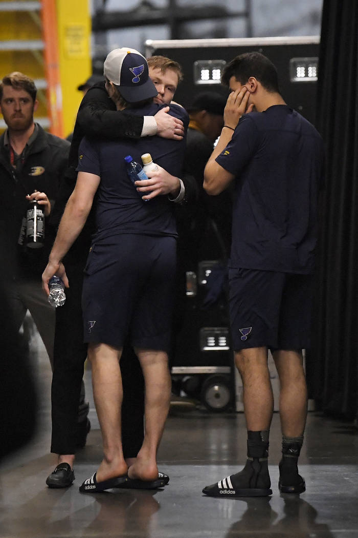 Anaheim Ducks left wing Max Jones, second from right, greets two members of the St. Louis Blues ...