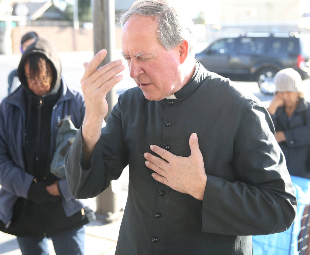 The Rev. Courtney Krier leads a prayer before a free breakfast at St. Joseph's Catholic Church ...