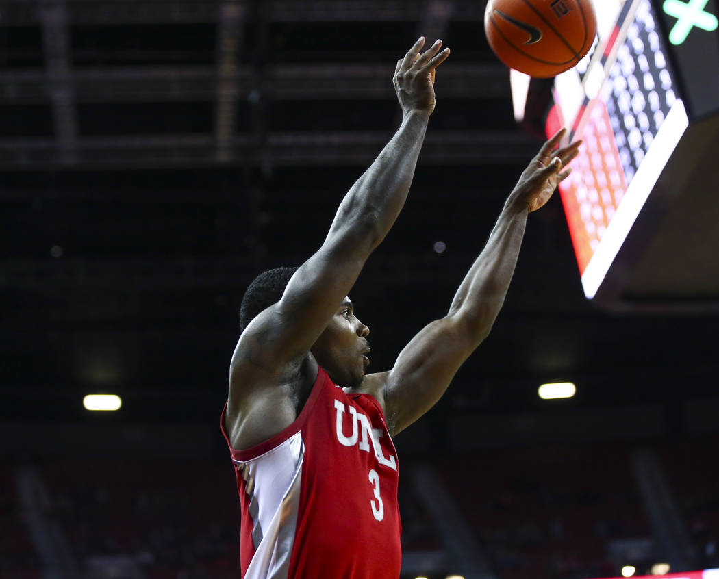 UNLV's Amauri Hardy (3) shoots to even the score against UNR during overtime in a basketball ga ...