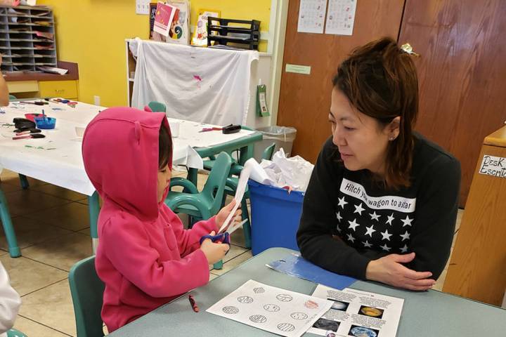 Fumika Takayama, working with her youngest child on labeling the solar system on Feb. 6, has ta ...