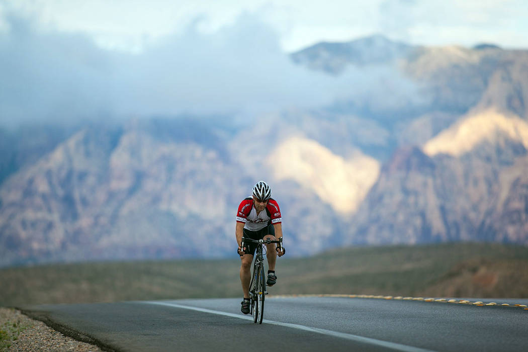 Cyclists ride along State Route 159 in Red Rock Canyon National Conservation Area in Las Vegas ...