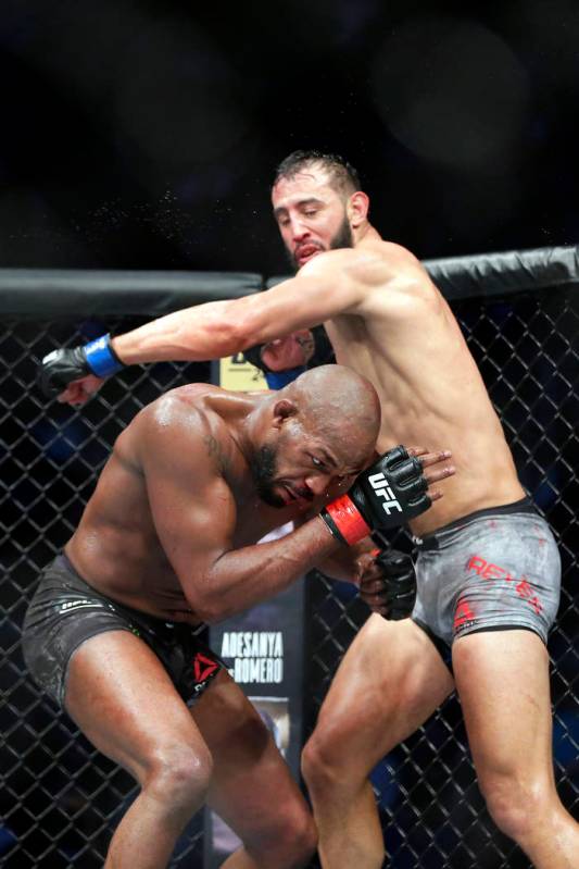 Jon Jones, left, ducks the swing by Dominick Reyes, right, during a light heavyweight mixed mar ...