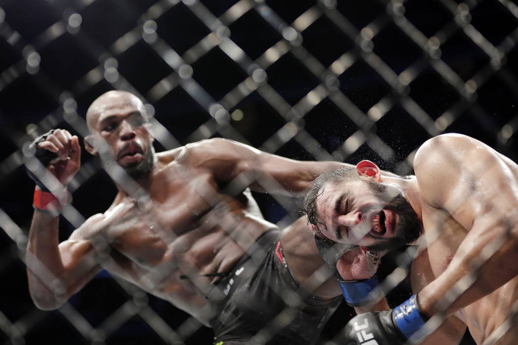 Jon Jones, left, and Dominick Reyes, right, during a light heavyweight mixed martial arts bout ...