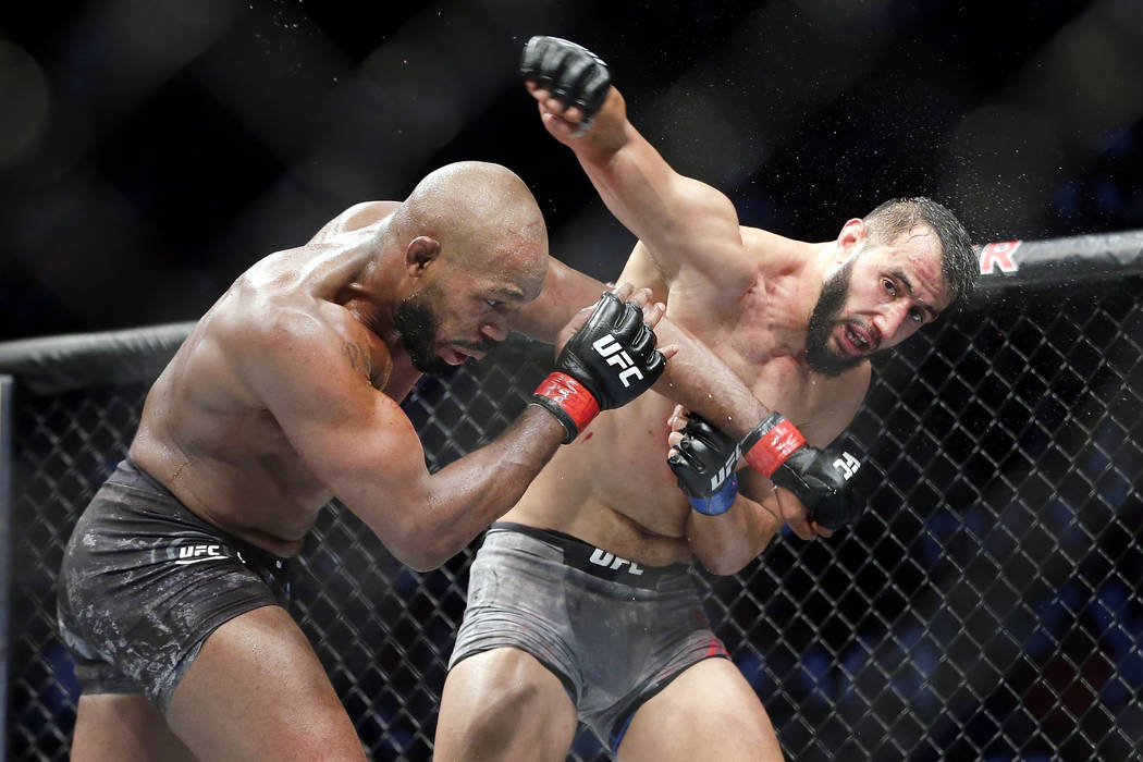 Jon Jones, left, and Dominick Reyes, right, during a light heavyweight mixed martial arts bout ...