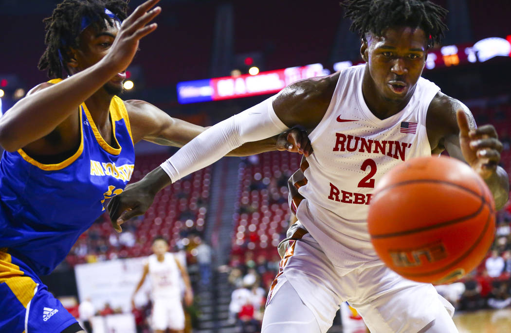 UNLV Rebels' Donnie Tillman (2) and San Jose State Spartans' Seneca Knight (13) chase after a l ...