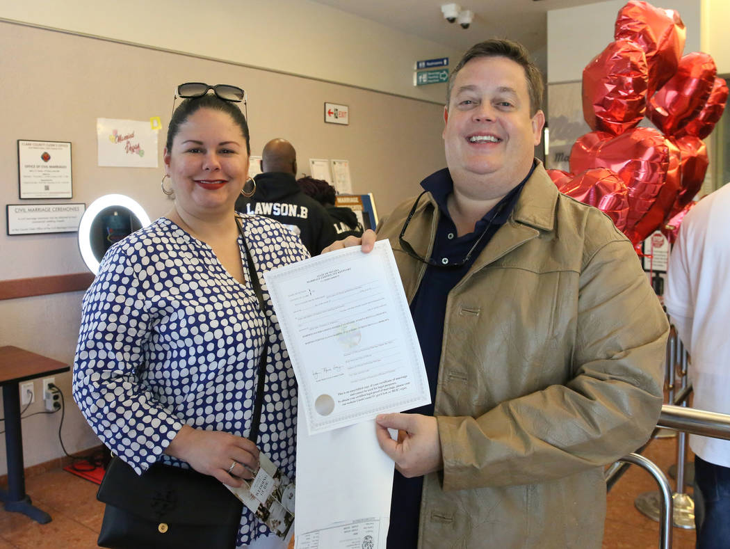 Roberto Garden and Martha Lugo of Puerto Rico show off their marriage license at the Marriage L ...