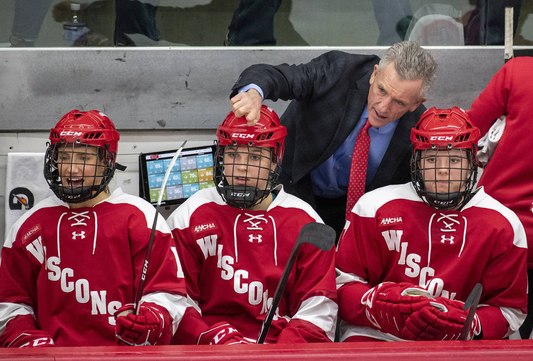 Wisconsin Badgers head coach Mark Johnson talks with his players during an NCAA college women&# ...