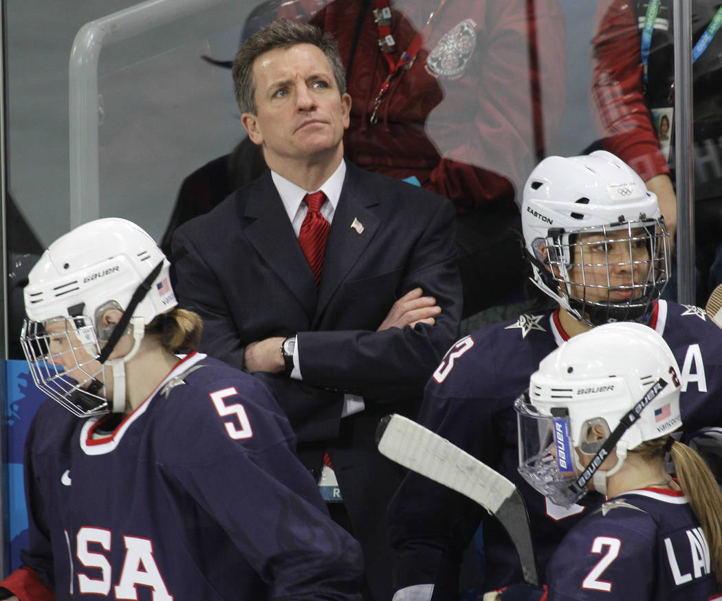 USA women's hockey head coach Mark Johnson watches his team play China in women's preliminary r ...