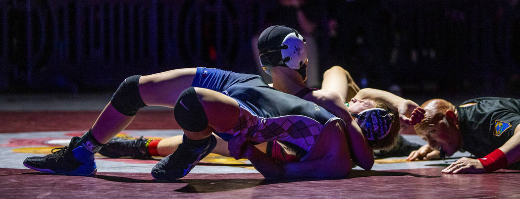 McQueen's Preston Harn, front, is close to being pinned by Cimarron-Memorial's Otto Cate-Cribar ...