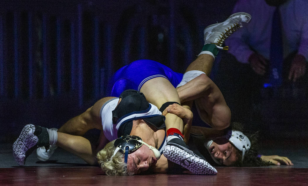 Shadow Ridge's Matthew Van Riel, left, battles on the mat with Spanish Spring's Devin Griffin i ...