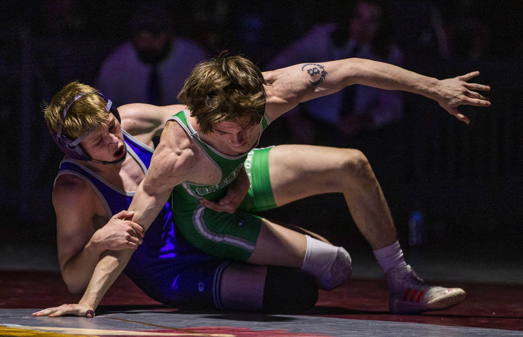 Spanish Spring's Keegan Hassell-Cramer , left, attempts to keep Green Valley's William Zernich ...