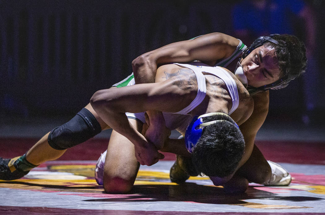 Reed's Alejandro Casarez, left, is dominated from behind by Green Valley's David Kalayanaprapru ...