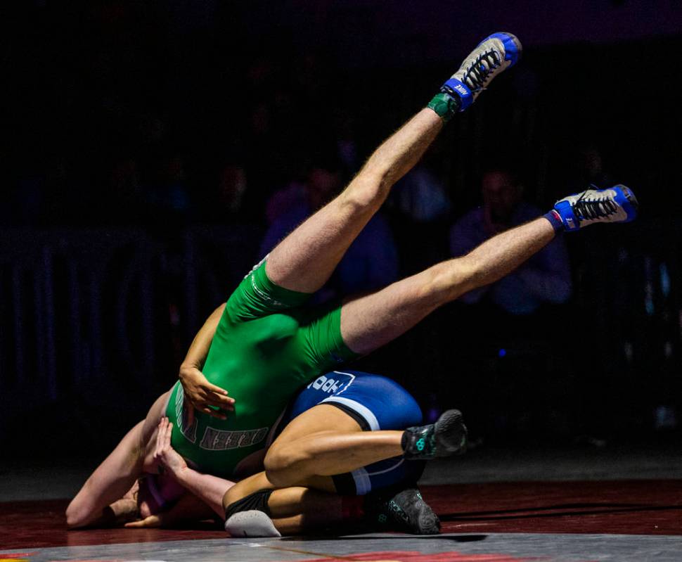 Green Valley's Derek Recktenwald, left, is tossed to the mat by Foothill's Micah Schneider in t ...