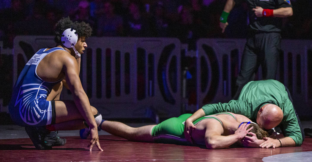 Foothill's Micah Schneider, left, looks to an injured Green Valley's Derek Recktenwald on the m ...