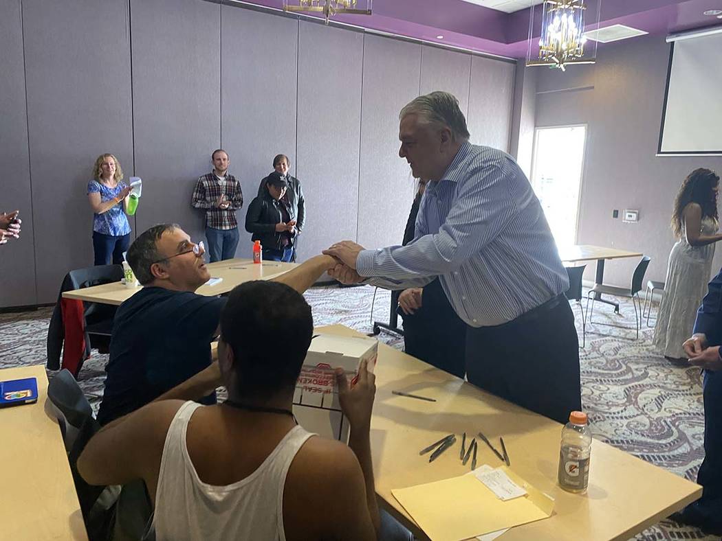 Gov. Steve Sisolak turns in his voting card on Saturday, Feb. 15, 2020. (Glenn Puit/Las Vegas R ...