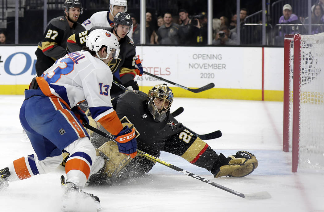 New York Islanders forward Mathew Barzal (13) shoots as Vegas Golden Knights goalie Marc-Andre ...