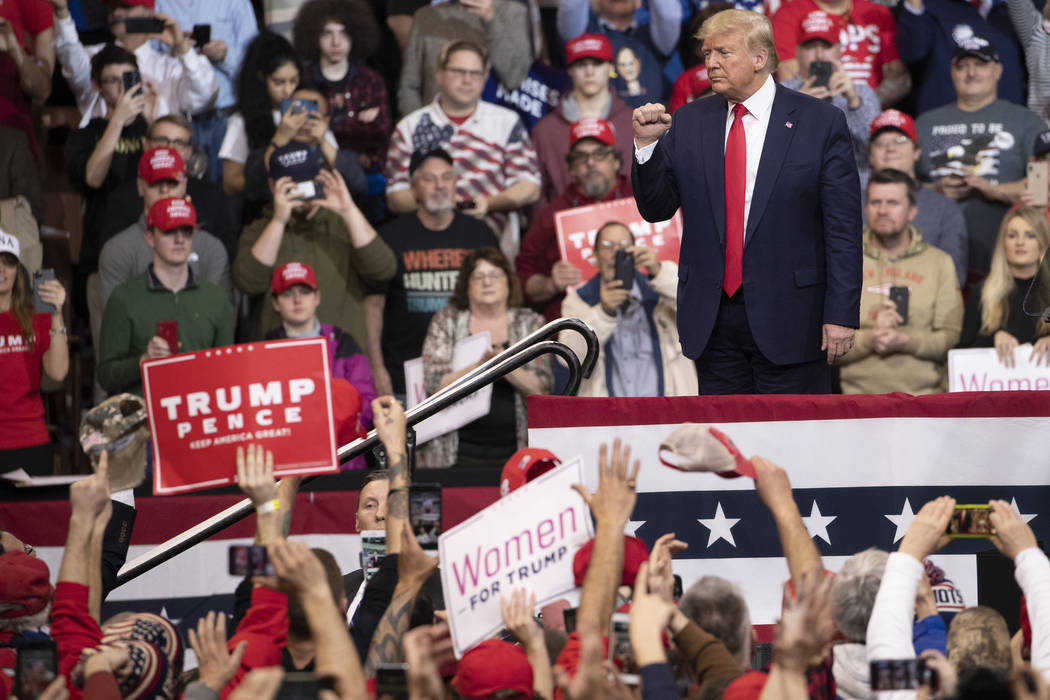 President Donald Trump gestures to supporters during a campaign rally, Monday, Feb. 10, 2020, i ...