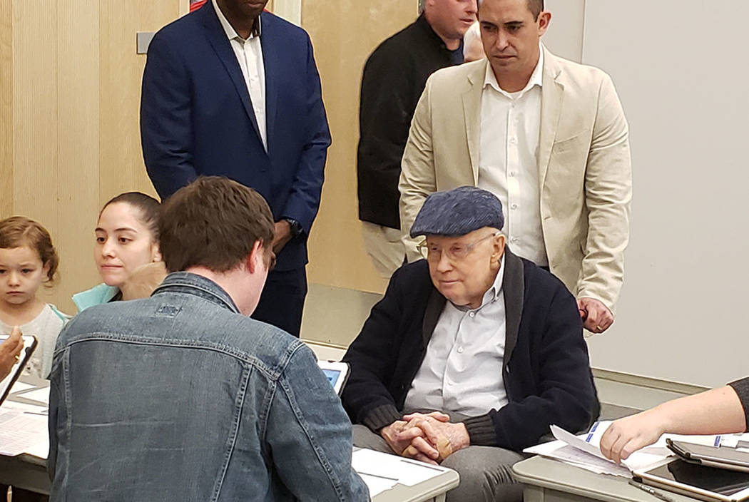 Former Senate Majority Harry Reid checks in with a volunteer at the Nevada State Democratic Par ...