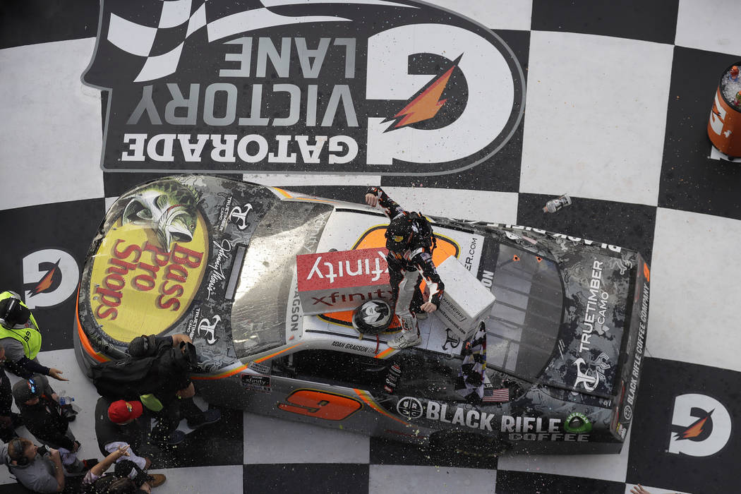 Noah Gragson celebrates on roof of his car in Victory Lane after winning the NASCAR Xfinity ser ...