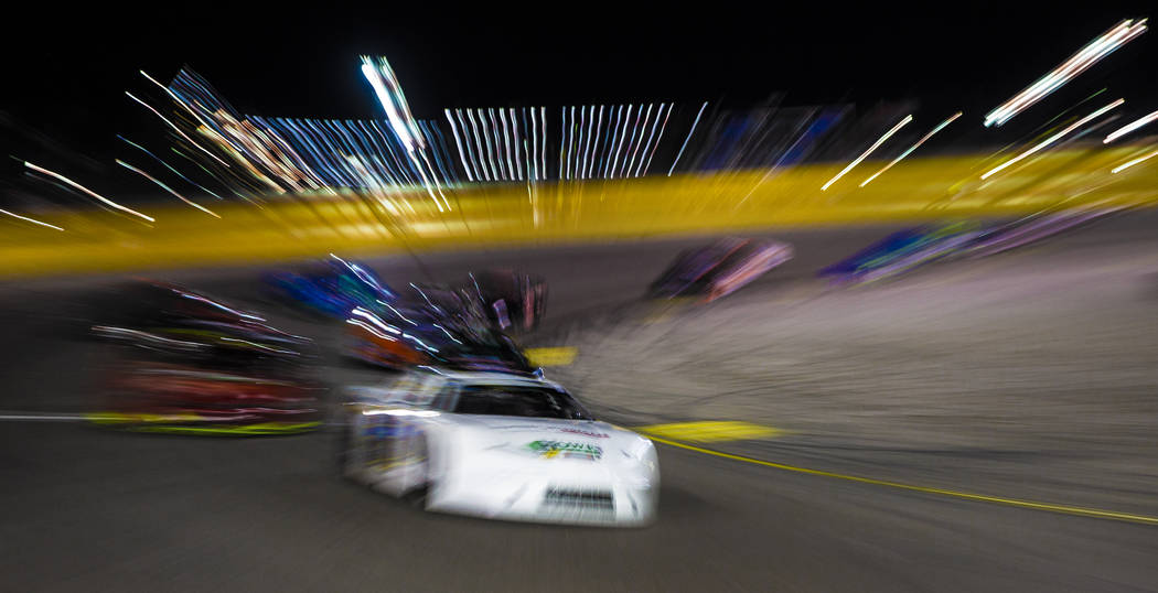 NASCAR star Kyle Busch turns the corner in the Star Nursery 100 Super Late Model feature race a ...