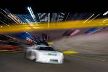 NASCAR star Kyle Busch turns the corner in the Star Nursery 100 Super Late Model feature race a ...