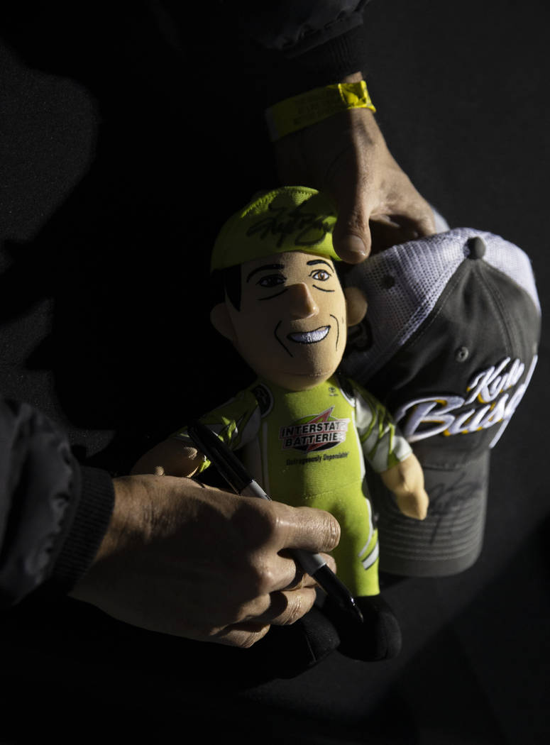 NASCAR star Kyle Busch signs autographs before the start of the Star Nursery 100 Super Late Mod ...