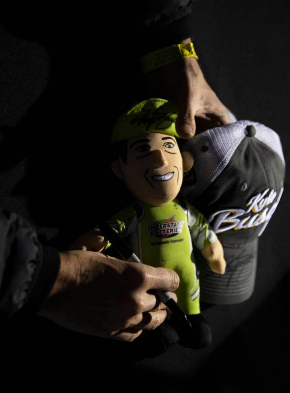 NASCAR star Kyle Busch signs autographs before the start of the Star Nursery 100 Super Late Mod ...