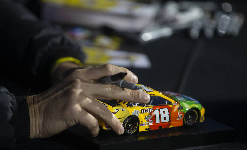 NASCAR star Kyle Busch signs autographs before the start of the Star Nursery 100 Super Late Mod ...